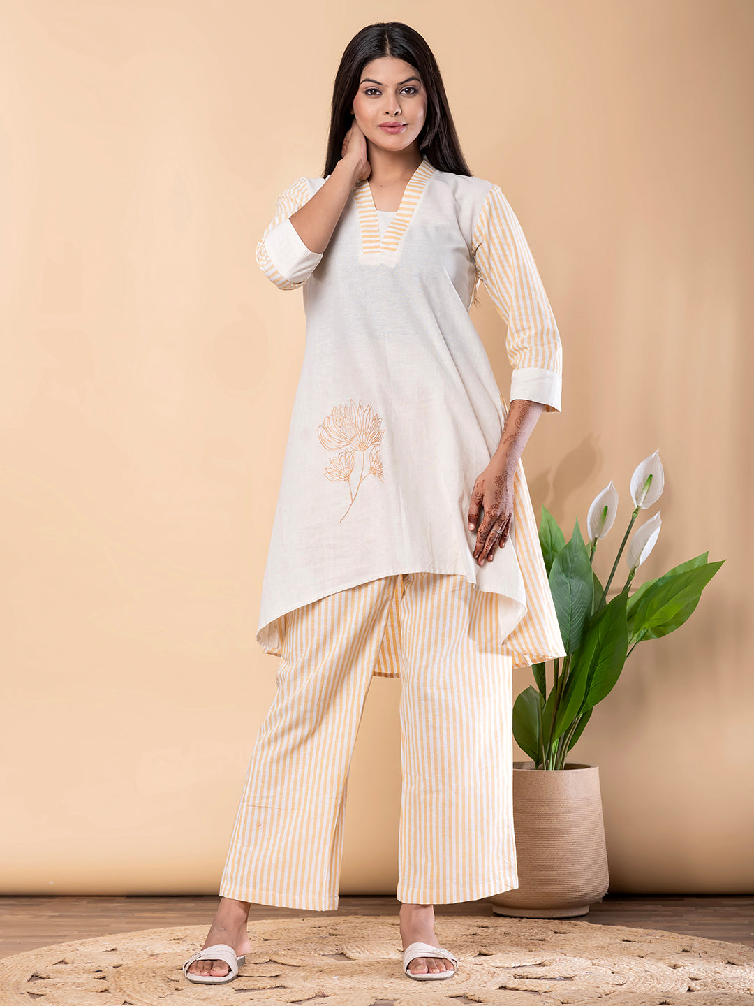 Kurta Design: V-neckline with striped detailing ;Three-quarter sleeves ;Asymmetrical high-low hem;Subtle floral embroidery on front