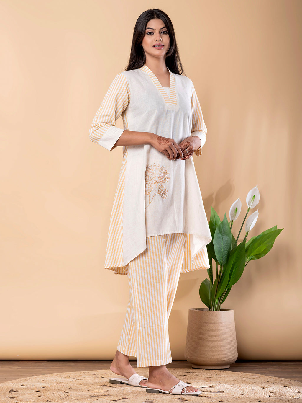 Kurta Design: V-neckline with striped detailing ;Three-quarter sleeves ;Asymmetrical high-low hem;Subtle floral embroidery on front